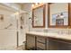 Bathroom featuring a double vanity with granite countertops and a glass-enclosed shower at 2958 Lapis Beach Dr, Las Vegas, NV 89117