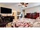 Cozy bedroom with a TV and a fireplace, leading to a walk-in closet at 2958 Lapis Beach Dr, Las Vegas, NV 89117