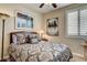 Comfortable bedroom with plantation shutters, stylish bedding, and elegant decor, lit by a charming Tiffany lamp at 2958 Lapis Beach Dr, Las Vegas, NV 89117
