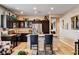 Modern kitchen with stainless steel appliances, dark cabinetry, and a granite countertop island at 2958 Lapis Beach Dr, Las Vegas, NV 89117