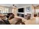 Well-lit living room with a large television, comfortable seating, and access to other rooms at 2958 Lapis Beach Dr, Las Vegas, NV 89117