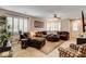 Bright living room featuring a sectional sofa, plantation shutters, and neutral decor at 2958 Lapis Beach Dr, Las Vegas, NV 89117