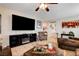 Comfortable living room with a large television, neutral decor, and tile flooring at 2958 Lapis Beach Dr, Las Vegas, NV 89117