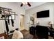 Bright office featuring a mounted TV, exercise equipment, and desk with chair at 2958 Lapis Beach Dr, Las Vegas, NV 89117