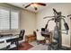 Well-lit office with plantation shutters, exercise equipment, desk area, and a unique vintage-style trunk at 2958 Lapis Beach Dr, Las Vegas, NV 89117