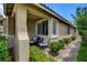 Cozy covered patio featuring comfortable seating, lush landscaping, and a quaint setting at 2958 Lapis Beach Dr, Las Vegas, NV 89117