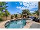 Backyard pool featuring a tiki bar, lush landscaping, and comfortable seating at 2958 Lapis Beach Dr, Las Vegas, NV 89117