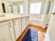 Bright bathroom featuring double sinks, bathtub, and glass enclosed shower at 3372 Wayward Ct, Las Vegas, NV 89129