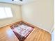 Cozy bedroom featuring hardwood floors, a window with natural light, and a decorative rug at 3372 Wayward Ct, Las Vegas, NV 89129
