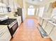Well-lit kitchen featuring stainless steel appliances, tile flooring, and ample counter space at 3372 Wayward Ct, Las Vegas, NV 89129