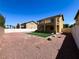 The backyard features synthetic grass, rock landscaping, fencing, and a covered patio at 3412 Catherine Mermet Ave, North Las Vegas, NV 89081
