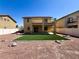 The backyard features synthetic grass, rock landscaping, fencing, and a covered patio at 3412 Catherine Mermet Ave, North Las Vegas, NV 89081