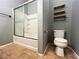 Bathroom featuring a shower-tub combination, toilet and shelving at 3412 Catherine Mermet Ave, North Las Vegas, NV 89081