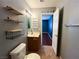 Well-lit bathroom featuring shelving, a mirror, and tiled flooring, situated near an inviting adjacent bedroom at 3412 Catherine Mermet Ave, North Las Vegas, NV 89081