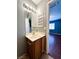 Functional bathroom with a vanity, mirror, tiled floor, and storage, flowing into the adjacent bedroom at 3412 Catherine Mermet Ave, North Las Vegas, NV 89081