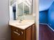 Charming bathroom featuring a vanity, a mirror, and tile flooring, adjacent to an inviting blue bedroom at 3412 Catherine Mermet Ave, North Las Vegas, NV 89081