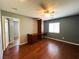 Cozy bedroom featuring hardwood floors, a ceiling fan, built-in desk, and natural light from a window at 3412 Catherine Mermet Ave, North Las Vegas, NV 89081
