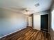 This bedroom boasts appealing wood floors, a ceiling fan, a closet with sliding doors, and neutral wall paint at 3412 Catherine Mermet Ave, North Las Vegas, NV 89081