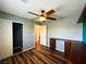 Bright bedroom with hardwood floors, a ceiling fan, built-in shelves, and a closet with sliding doors at 3412 Catherine Mermet Ave, North Las Vegas, NV 89081