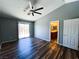 Bright bedroom with wood floors, ceiling fan, and a sliding glass door at 3412 Catherine Mermet Ave, North Las Vegas, NV 89081