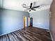 Spacious bedroom with wood floors, ceiling fan, and multiple doors leading to other rooms at 3412 Catherine Mermet Ave, North Las Vegas, NV 89081