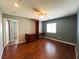 Spacious bedroom featuring wood floors, ceiling fan, and a built-in cabinet at 3412 Catherine Mermet Ave, North Las Vegas, NV 89081