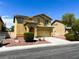 Two story home with solar panels, landscaped front yard, and an attached garage at 3412 Catherine Mermet Ave, North Las Vegas, NV 89081