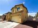 Side view of a two story home with a front-facing attached two car garage at 3412 Catherine Mermet Ave, North Las Vegas, NV 89081