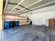 Spacious garage with storage shelves, door to interior, and water conditioning at 3412 Catherine Mermet Ave, North Las Vegas, NV 89081