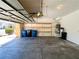 Spacious garage with storage shelves, door to interior, and water conditioning at 3412 Catherine Mermet Ave, North Las Vegas, NV 89081