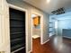 Hallway featuring wooden floors and access to a walk-in closet and laundry room at 3412 Catherine Mermet Ave, North Las Vegas, NV 89081