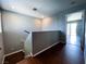 Hallway with hardwood floors leading to a bright room with a glass door and neutral paint at 3412 Catherine Mermet Ave, North Las Vegas, NV 89081
