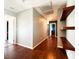 Spacious hallway featuring wooden floors, access to another rooms, and floating wood shelves at 3412 Catherine Mermet Ave, North Las Vegas, NV 89081