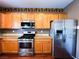 A well-equipped kitchen with stainless steel appliances and wooden cabinets at 3412 Catherine Mermet Ave, North Las Vegas, NV 89081