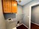Laundry room with wooden cabinets, wire shelving, and bright lighting at 3412 Catherine Mermet Ave, North Las Vegas, NV 89081