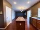 Open-concept living space with hardwood floors and neutral paint, flowing from kitchen to dining at 3412 Catherine Mermet Ave, North Las Vegas, NV 89081