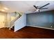 Open living area with hardwood floors, a ceiling fan, and a staircase to the second floor at 3412 Catherine Mermet Ave, North Las Vegas, NV 89081