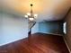 Bright living room featuring hardwood floors, a ceiling fan, and a chandelier at 3412 Catherine Mermet Ave, North Las Vegas, NV 89081
