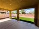 Relax on this covered patio with pillars overlooking the synthetic grass and rock landscaping at 3412 Catherine Mermet Ave, North Las Vegas, NV 89081