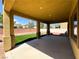 Relax on this covered patio with pillars overlooking the synthetic grass and rock landscaping at 3412 Catherine Mermet Ave, North Las Vegas, NV 89081