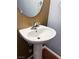 Close-up of a modern pedestal sink with a chrome faucet in a stylish powder room at 3412 Catherine Mermet Ave, North Las Vegas, NV 89081