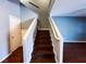 Staircase featuring hardwood floors, gray walls, white trim, and blue accent wall at 3412 Catherine Mermet Ave, North Las Vegas, NV 89081