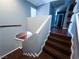 Modern staircase with hardwood steps leading to an upper level with natural light and views at 3412 Catherine Mermet Ave, North Las Vegas, NV 89081