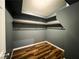 The walk-in closet has wooden floorboards, metal bars for hanging items, and dark gray walls at 3412 Catherine Mermet Ave, North Las Vegas, NV 89081