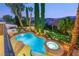 Twilight aerial view of a pool, hot tub, desert landscaping, and surrounding homes at 3535 Coventry Gardens Dr, Las Vegas, NV 89135