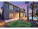Backyard with pool, patio, mature landscaping, and putting green creates a relaxing atmosphere at twilight at 3535 Coventry Gardens Dr, Las Vegas, NV 89135
