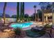 Backyard features a pool, spa, lounge chairs, palm trees and manicured landscaping at 3535 Coventry Gardens Dr, Las Vegas, NV 89135
