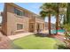 Home's backyard with pool, patio, mature landscaping, and putting green offers a private outdoor retreat at 3535 Coventry Gardens Dr, Las Vegas, NV 89135