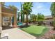 Lush backyard with pool, patio seating, putting green, and mature shade trees at 3535 Coventry Gardens Dr, Las Vegas, NV 89135