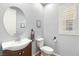 Stylish powder room featuring modern fixtures, a vessel sink, and neutral tones at 3535 Coventry Gardens Dr, Las Vegas, NV 89135